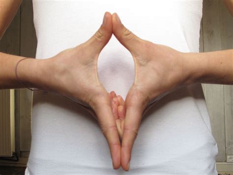 a woman with her hands in the shape of a heart on her stomach is shown