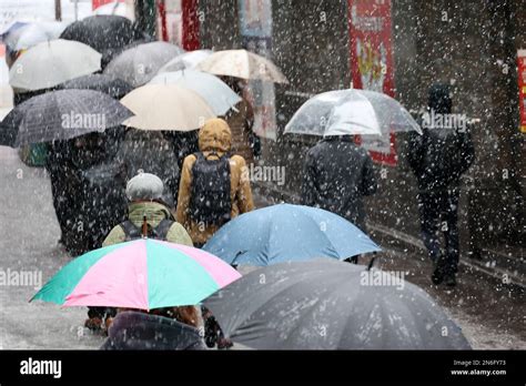 Tokyo, Japan. 10th Feb, 2023. People walk in snow at a terminal station ...