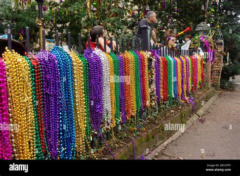 Mardi Gras beads displayed on fencing along St Charles Av, in New ...