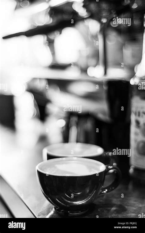 making espresso coffee BW black and white close up detail with modern ...