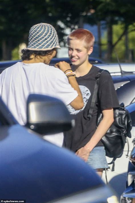 Brad Pitt and Angelina Jolie's daughter Shiloh shows off pink buzz cut as she catches up with ...