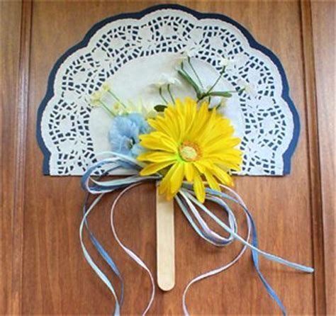 a paper doily with flowers and ribbons on it