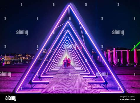 Purple coloured gate of light or light tunnel installation made of ...