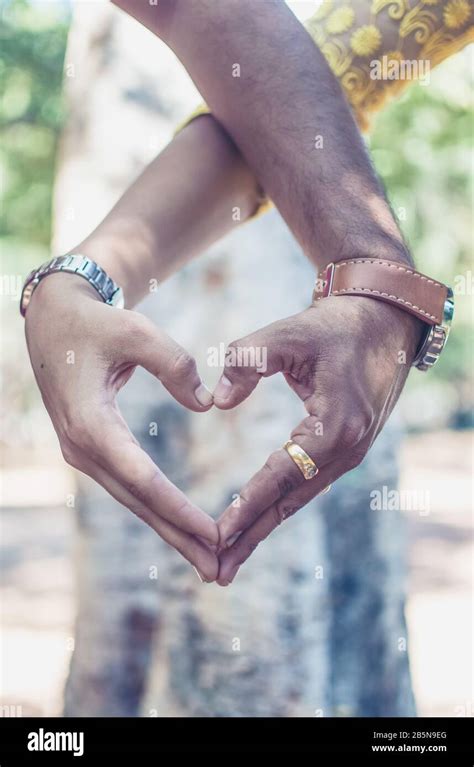 Two Couples holding hands in Heart Shape Stock Photo - Alamy