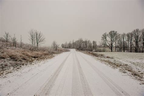 Snow Covered Winter Road with Tire Tracks Stock Photo - Image of ...