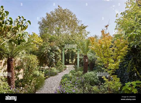 Garden path leading to house. Chevening Road House, London, United Kingdom. Architect: Monica ...