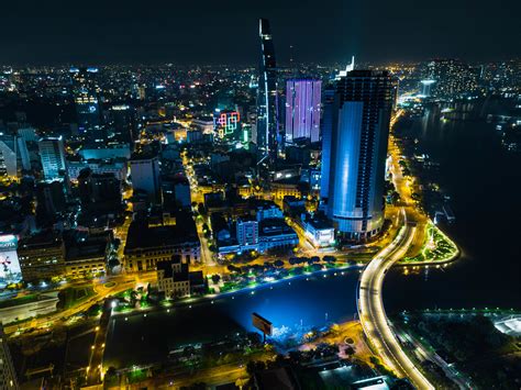 Drone Photo of a Bridge and Power Lines over Saigon River with Apartment Buildings, Bitexco ...