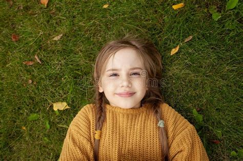 Happy Kid Girl in Yellow Sweater on Green Grass Background, Top View Stock Photo - Image of gold ...