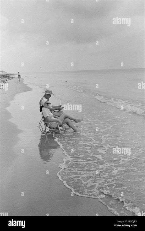 Senior couple sitting on the beach Stock Photo - Alamy