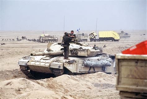 A British Challenger main battle tank waits by the Basra-Kuwait Highway near Kuwait City ...