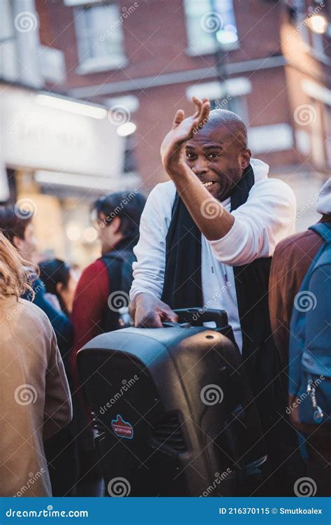 A Man with a Large Speaker Running Trough Crowd in Soho Editorial Image ...