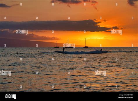 Sunset at Lahaina Harbor on Maui ,with silhouetted surfers Stock Photo - Alamy