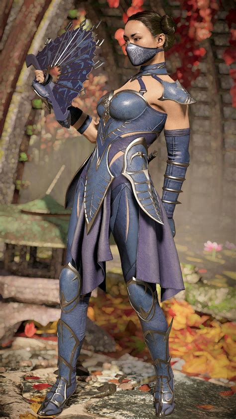 a woman dressed in armor holding a blue bird and wearing a mask on her face