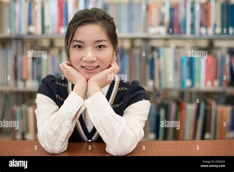 Student resting on wooden shelf Stock Photo - Alamy