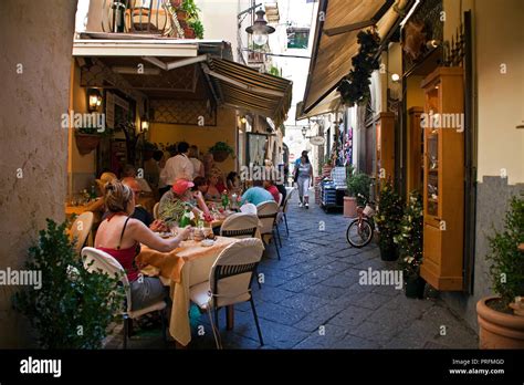 Restaurants and shops at a narrow alley, old town of Sorrento ...