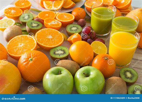 Kitchen Table Set with Various Types of Fruit and Juices. Stock Image ...