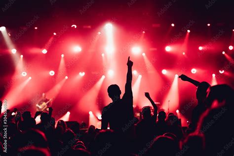 cheering crowd of unrecognized people at a rock music concert. crowd in ...