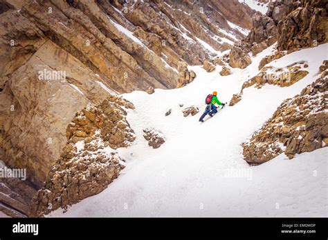 Mountaineer climbing a steep slope Stock Photo - Alamy