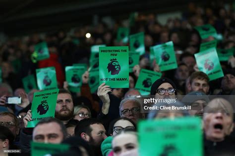 Everton supporters hold protest banners in the stands reading... News ...