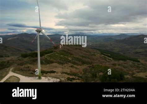 This is a video of a wind farm with multiple windmills, filmed near San ...