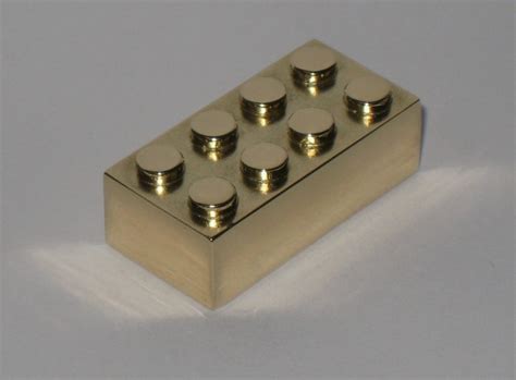 Ultra-rare solid gold Lego brick sells at auction for price of a large ...