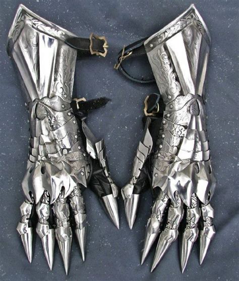 two metal gloves with spikes attached to them