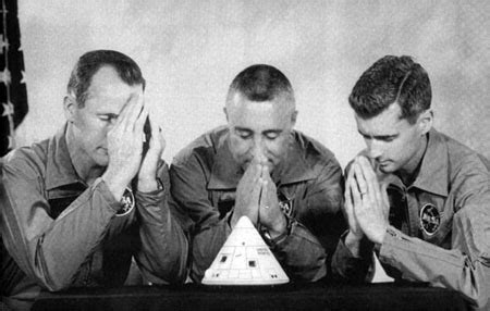 The Apollo 1 crew jokingly pray to a model capsule in a mock crew ...