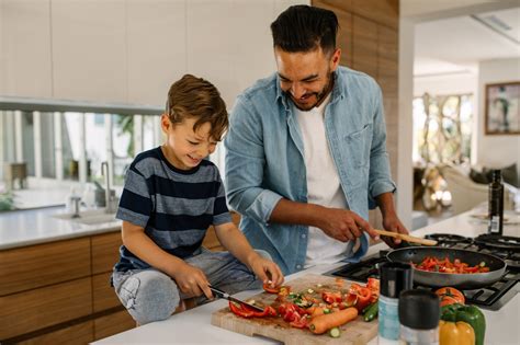 Father and son preparing food in kitchen - Wayfarer