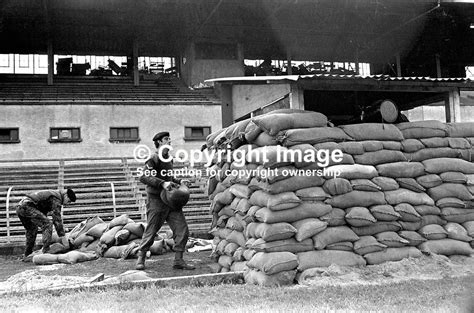 British soldiers erect an observation post on the playing pitch at ...