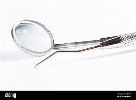 Two Dental Tools : Dental mirror and probe on white background Stock Photo - Alamy