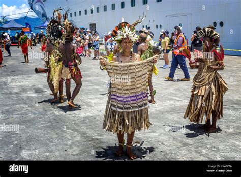 Indigenous dancers in traditional costume greet the arrival of a cruise ...