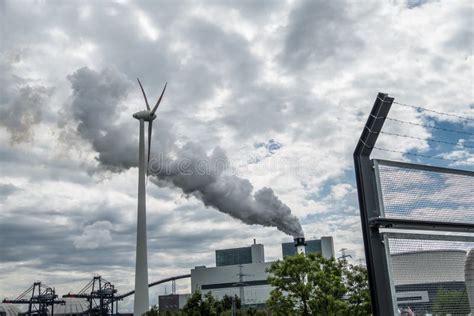 Wind Power Turbine Standing in the Pollution Clouds of a Power Plant Stock Photo - Image of ...