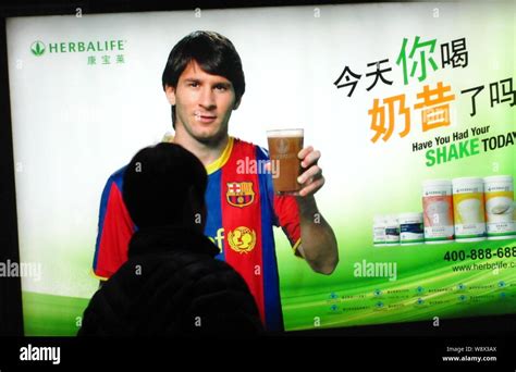 --FILE--A pedestrian walks past an advertisement for Herbalife products ...