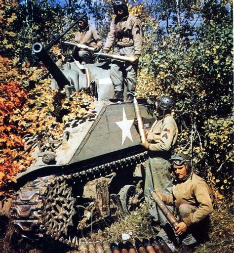 The crew of an M4 Sherman tank loads up on ammo. Pine Camp, New York ...