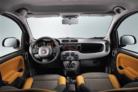 the interior of a small car with yellow and black leather seats ...