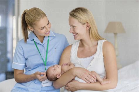 Mother and nurse with newborn baby stock photo