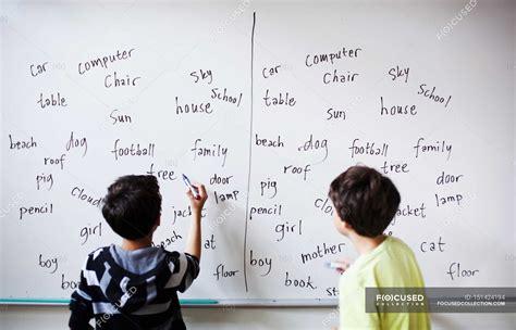 Boys writing on whiteboard — School Building, horisont - Stock Photo | #151424194