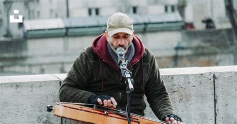 Man playing guitar and singing on street during daytime photo – Free Grey Image on Unsplash