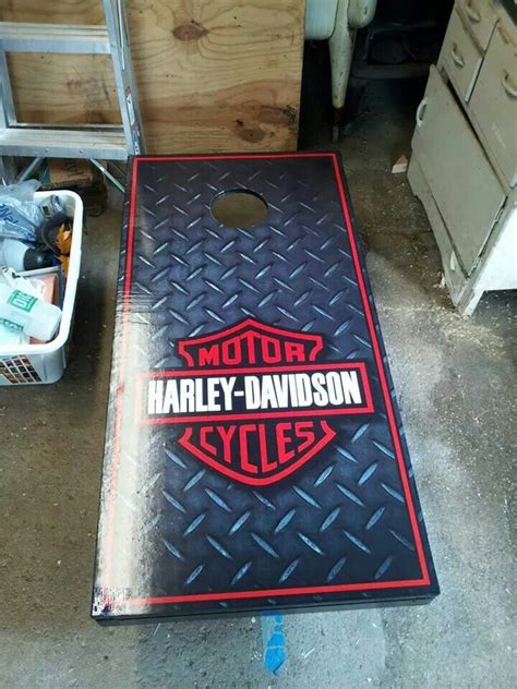 an image of a harley davidson cornhole game set up on the floor in a garage