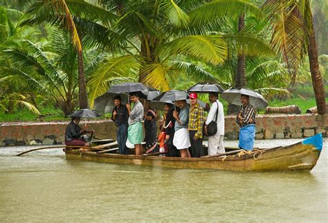 Its just another day for these daily boat commuters - a scene from a Kerala Village on a rainy ...