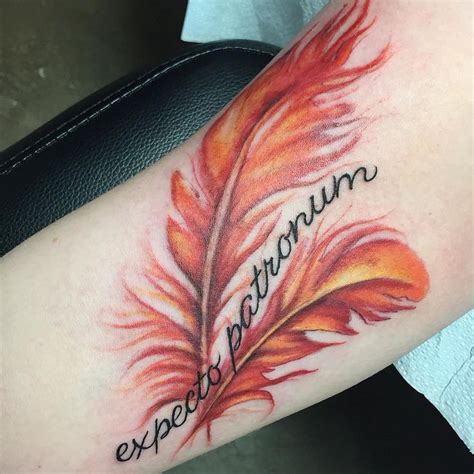 phoenix feather tattoo - minus the words | Feather tattoos, Tattoos, Trendy tattoos