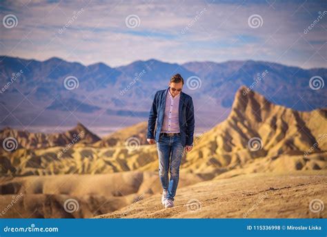 Young Man Walking Alone in the Desert of Death Valley Stock Photo ...