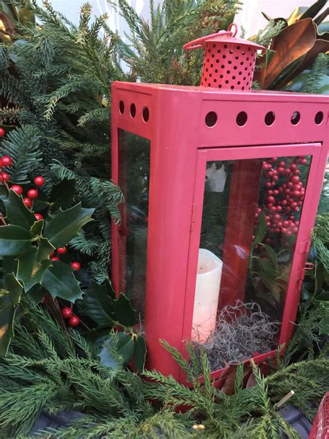 Christmas urn with fresh greenery, red lantern, flameless candle, large ornaments and red ...