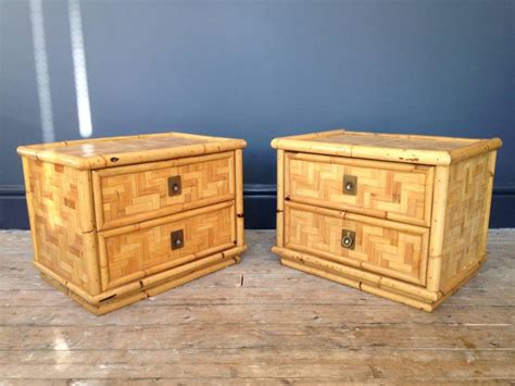 A pair of bamboo and brass bedside tables