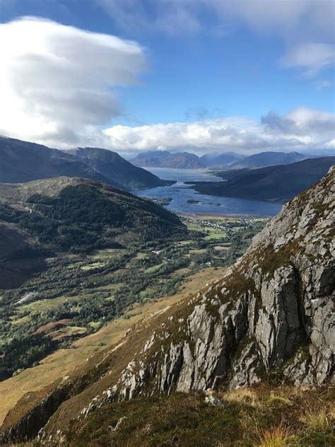 the view from the top of a mountain looking down at some water and ...