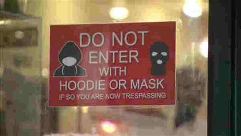 Signs outside some businesses in Harlem say 'No Hoodies or masks ...