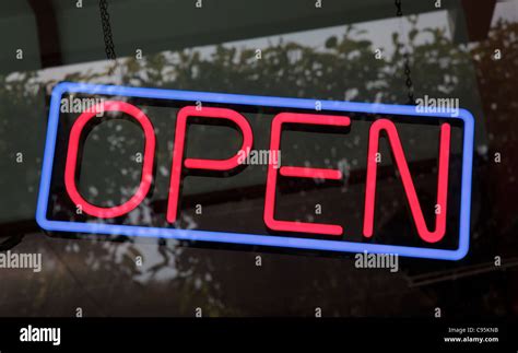 A neon store "open" sign hangs in an Austin, Texas storefront Stock Photo - Alamy