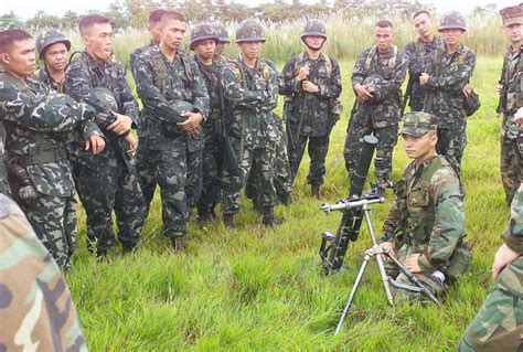 Download Image of A group of Philippine Marines gather to watchUS Marine Corps (USMC) personnel ...