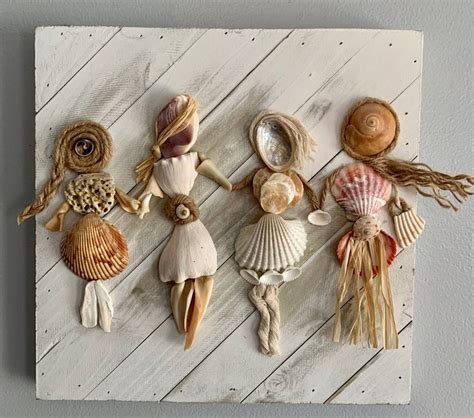 several seashells and shells are arranged on a white wooden paneled ...