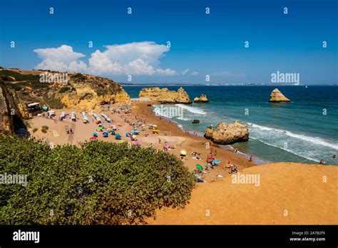 Praia Dona Ana, Portugal - September 7, 2019 - People enjoying a day at the beach at Praia Dona ...